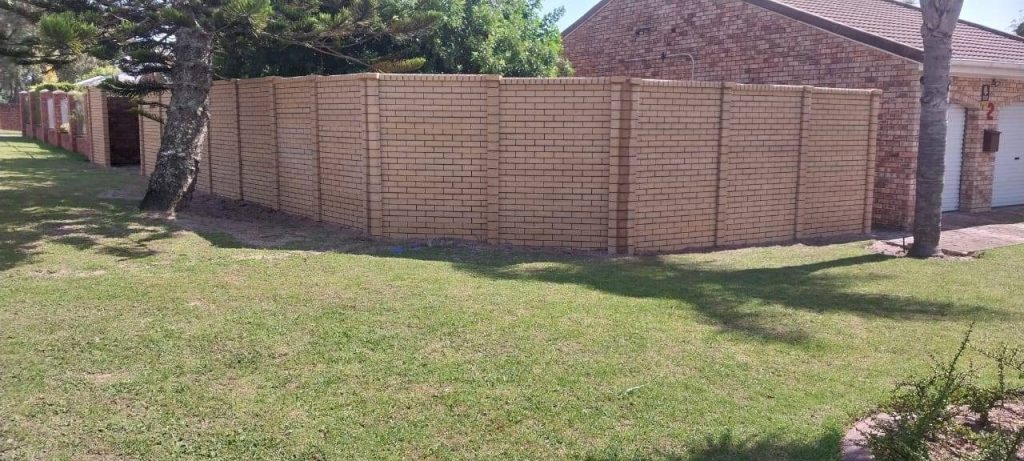 a brick wall in a yard