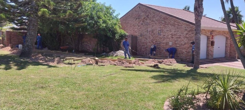 a group of men working in a yard