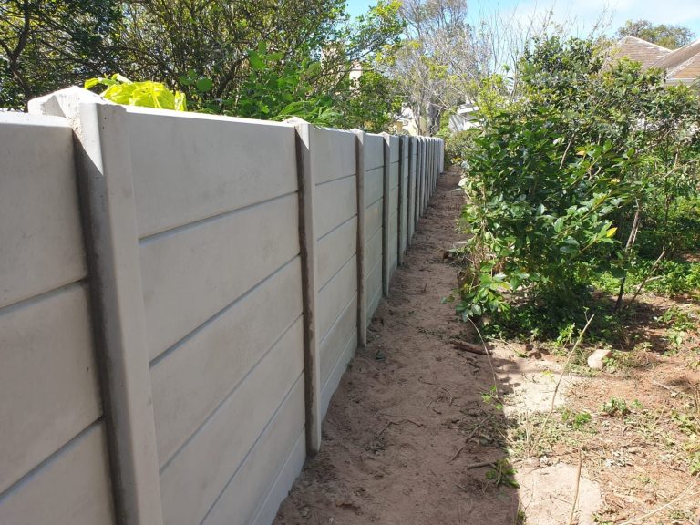 a wall with a fence in the middle